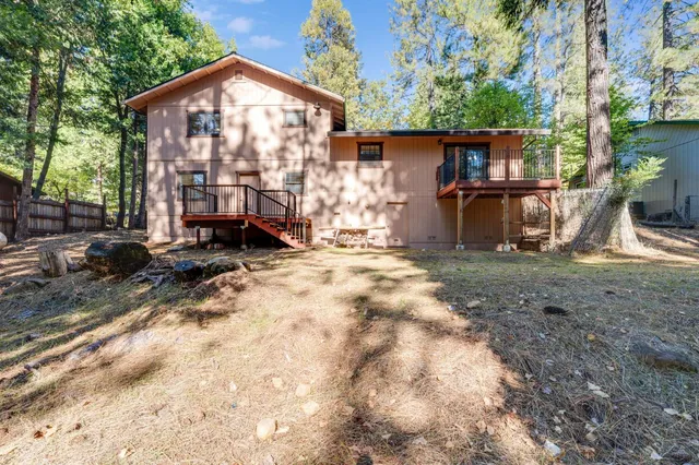 a view of a house with backyard and sitting area