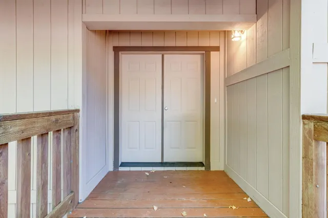 a view of a small space with wooden floor and a window