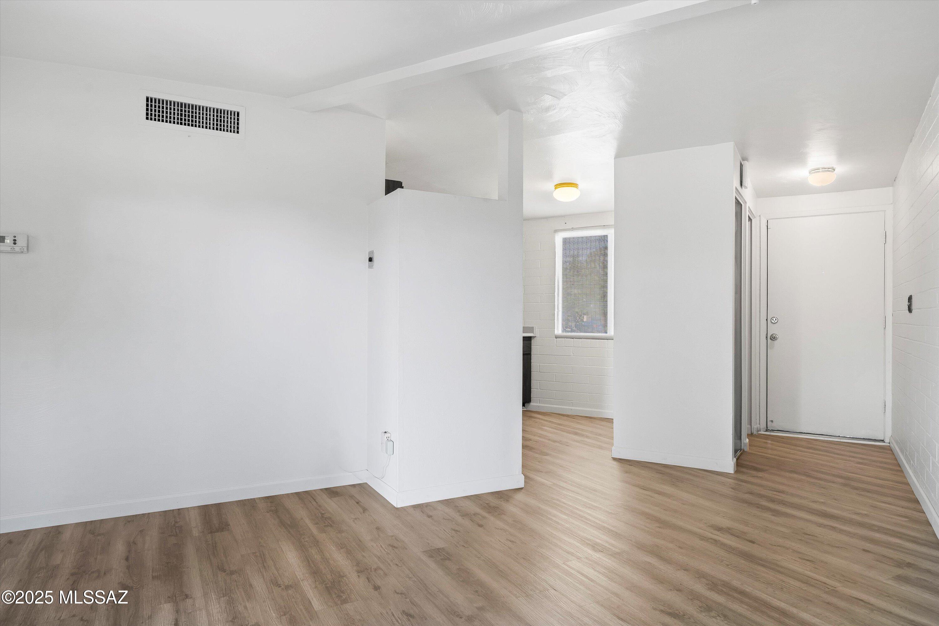 1505 West Roger Road Tucson, AZ 85705 - Photo 4 of 24 a view of an empty room with wooden floor