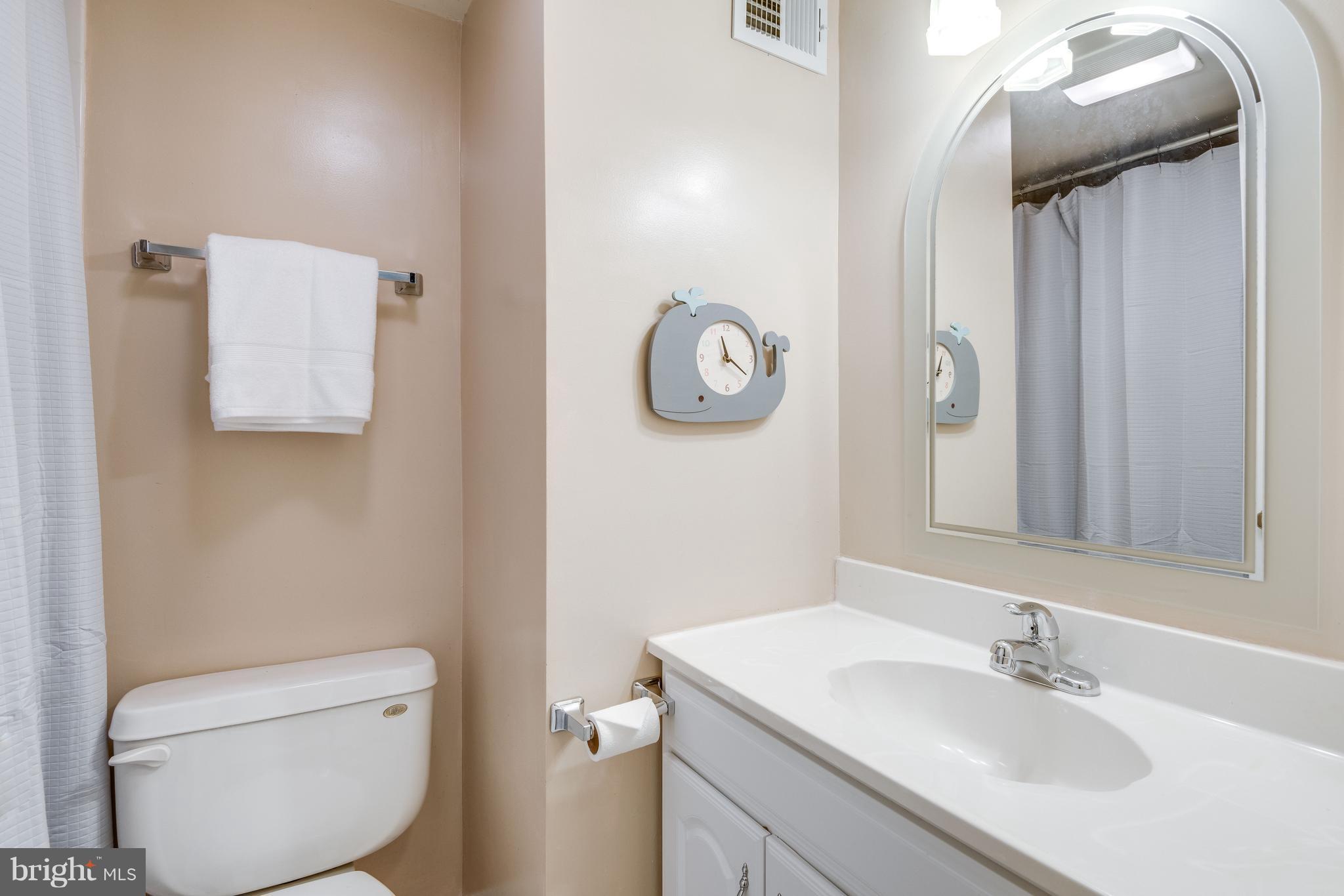 1804 Golf View Court Reston, VA 20190 - Photo 15 of 30 a bathroom with a toilet sink vanity and mirror