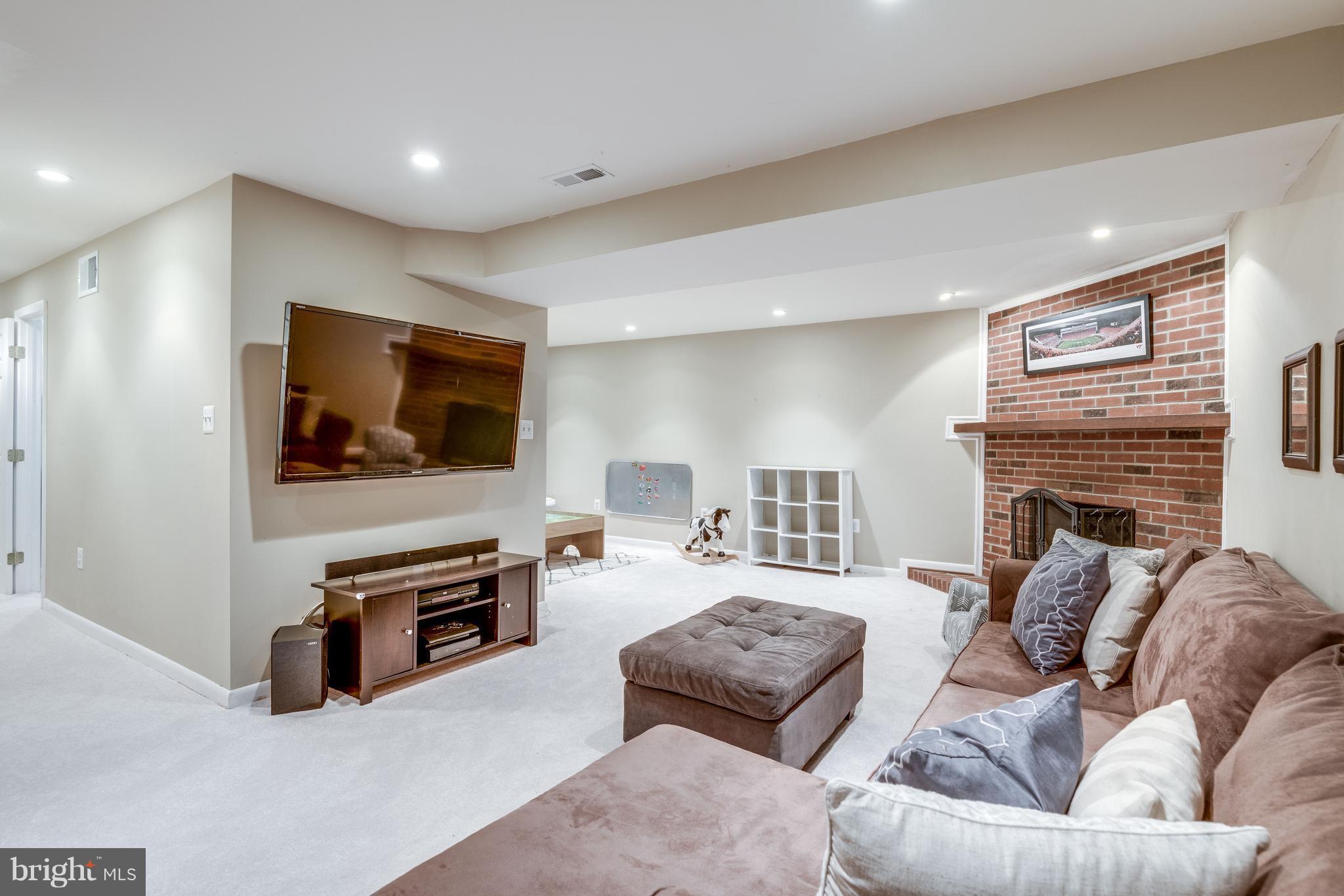 1804 Golf View Court Reston, VA 20190 - Photo 19 of 30 a living room with furniture and a flat screen tv