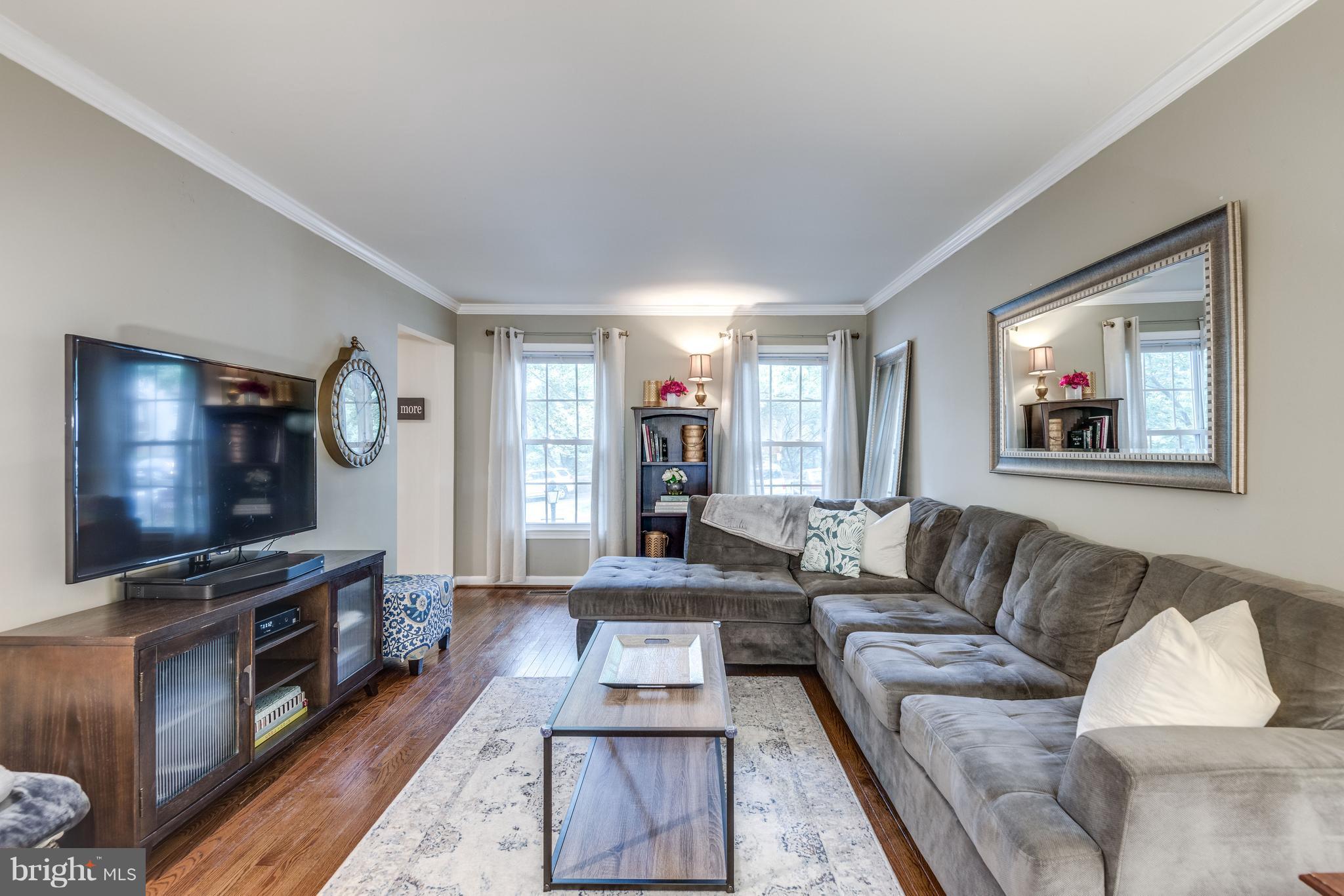 1804 Golf View Court Reston, VA 20190 - Photo 3 of 30 a living room with furniture and a flat screen tv