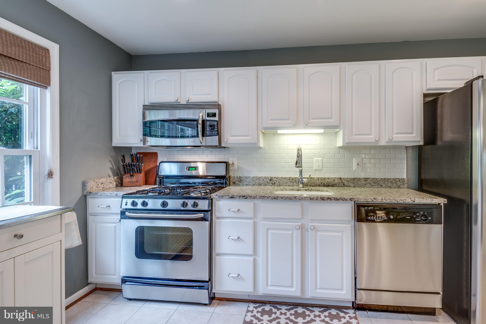 1804 Golf View Court Reston, VA 20190 - Photo 7 of 30 a kitchen with granite countertop white cabinets and appliances