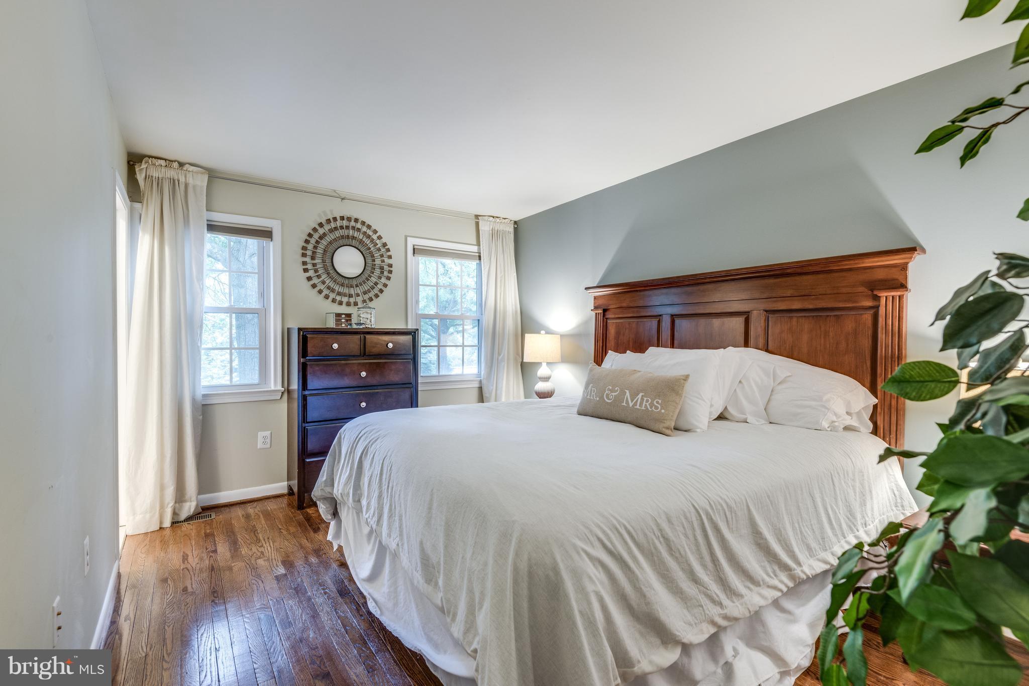1804 Golf View Court Reston, VA 20190 - Photo 9 of 30 a bedroom with a bed and a tv on the dresser