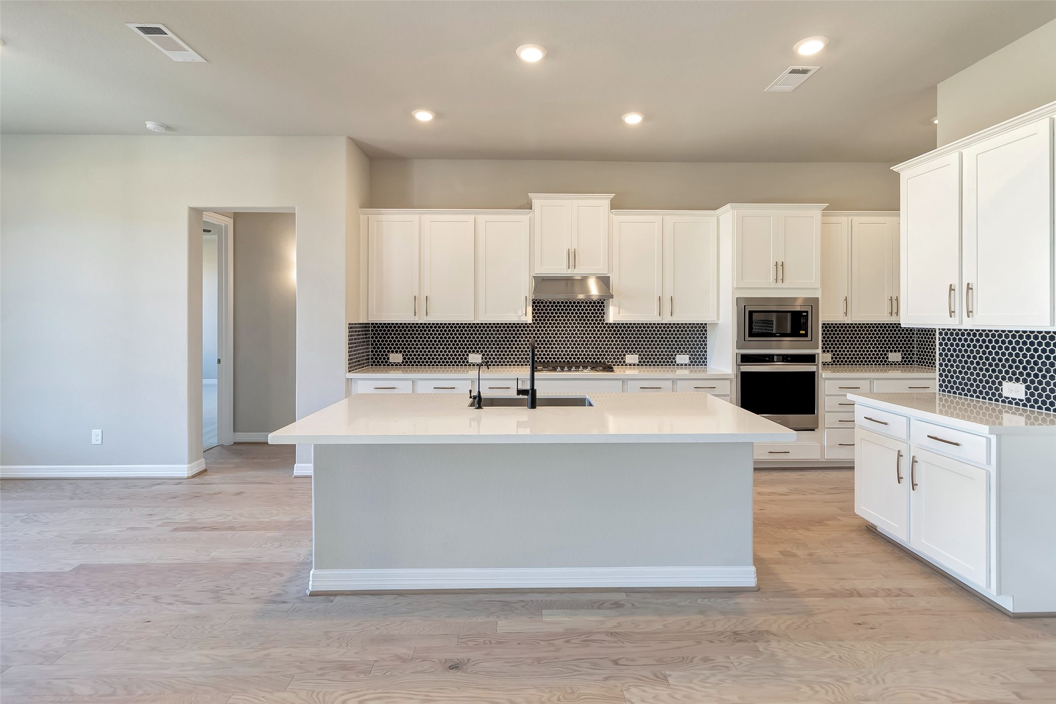 30827 Swift Hill Waller, TX 77484 - Photo 2 of 19 a view of kitchen with stainless steel appliances granite countertop a stove top oven a sink and white cabinets