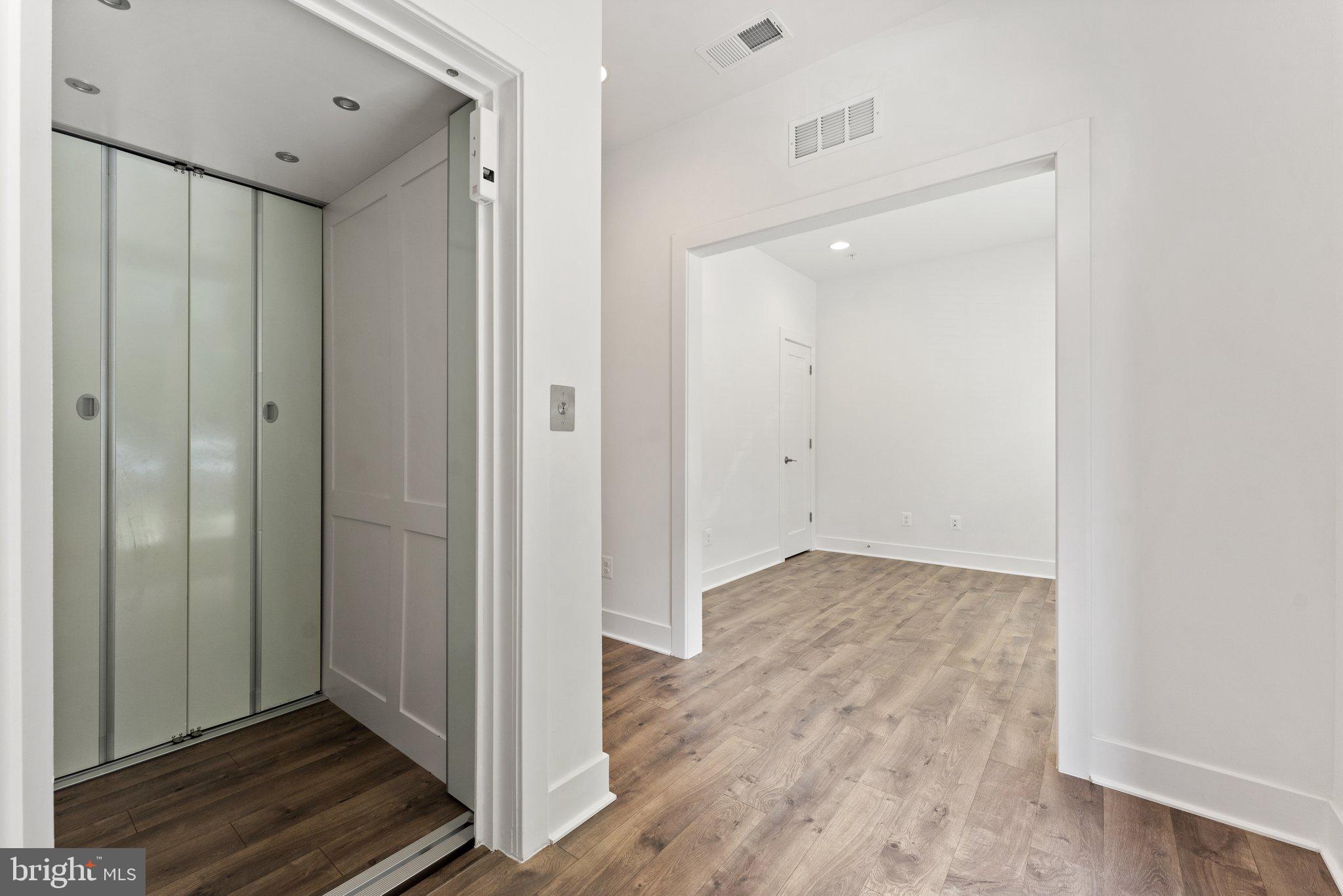 1876 Michael Faraday Drive Reston, VA 20190 - Photo 10 of 58 lower level elevator view to living room