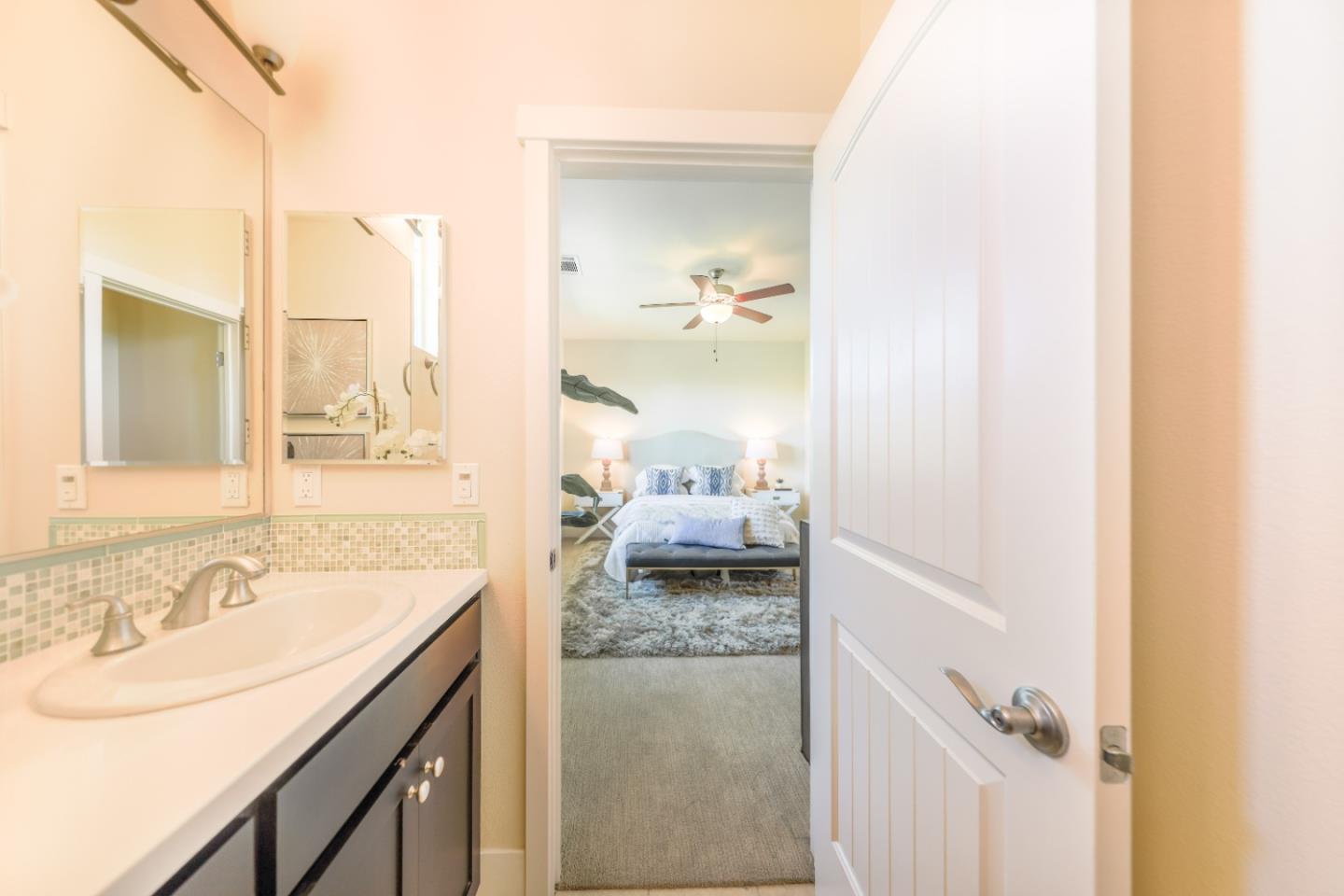1095 Interlaken Terrace Sunnyvale, CA 94089 - Photo 13 of 25 a en suite bathroom with a granite countertop sink and a mirror