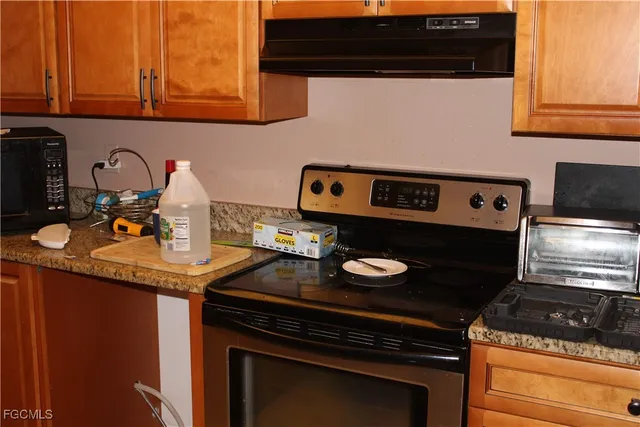 a kitchen with a stove and a microwave