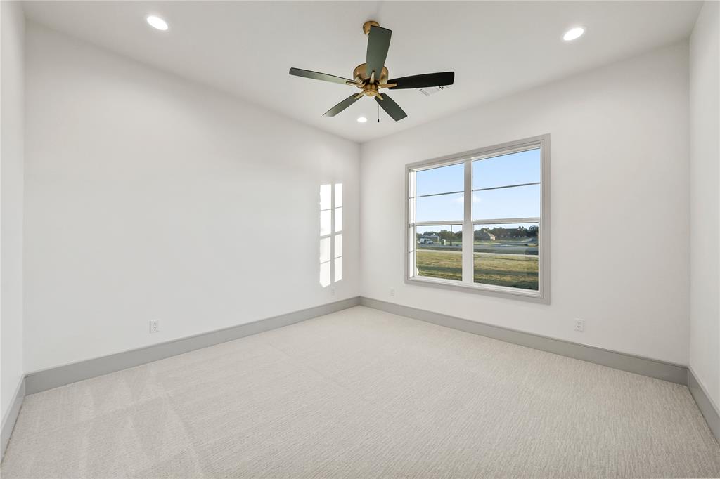724 Cooper Trail Weatherford, TX 76087 - Photo 20 of 37 Light-filled room featuring a large window, recessed lighting, and a ceiling fan with gold-tone accents