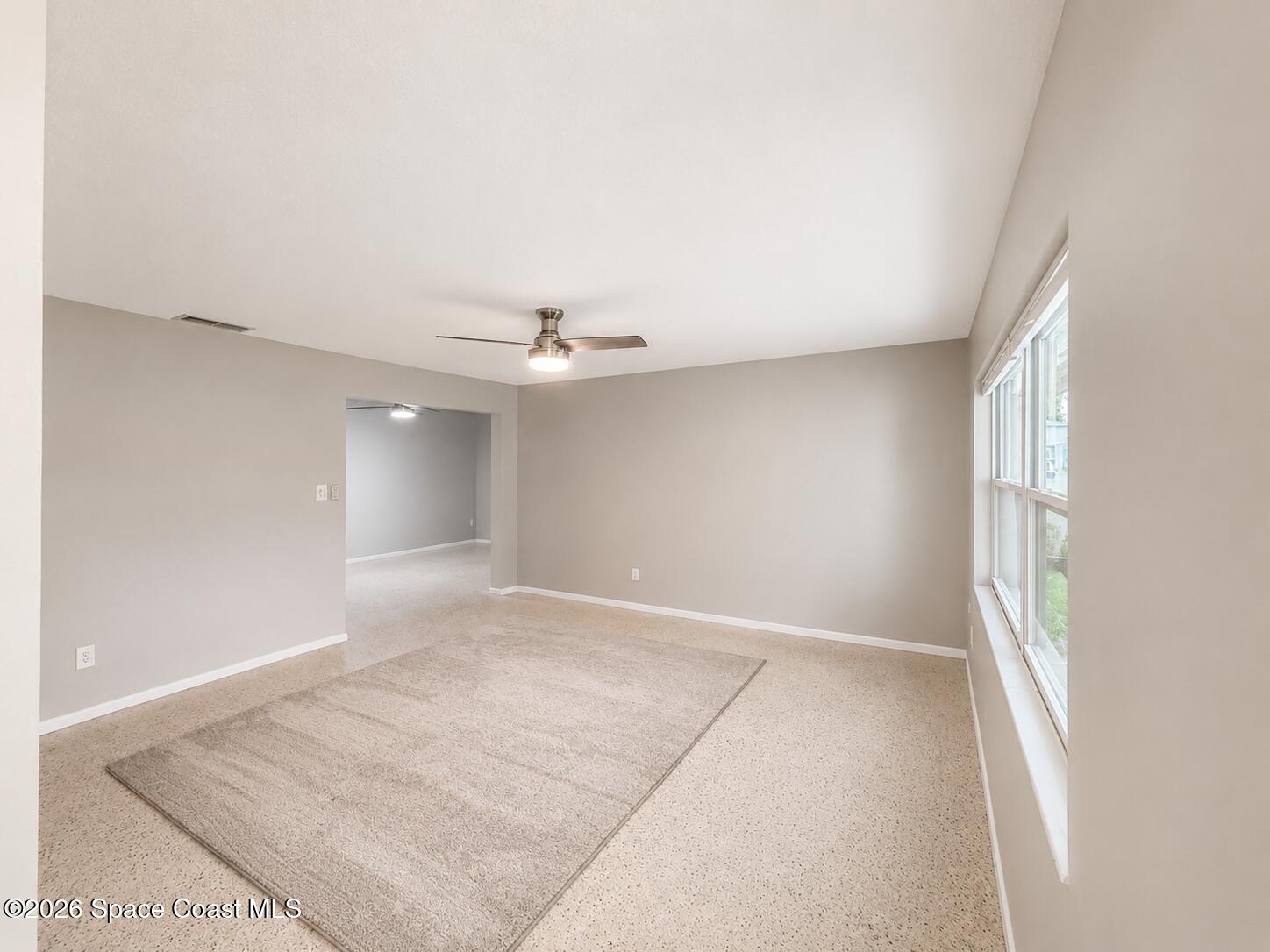 987 Kings Post Road Rockledge, FL 32955 - Photo 26 of 30 an empty room with a natural light