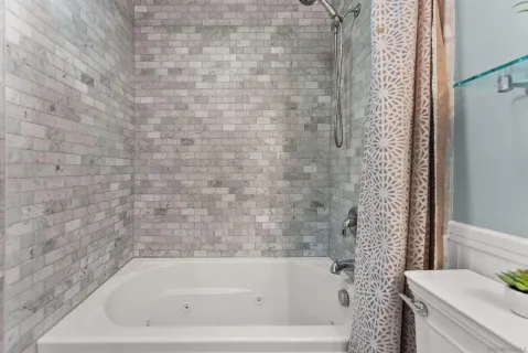 a bathroom with a bathtub and shower