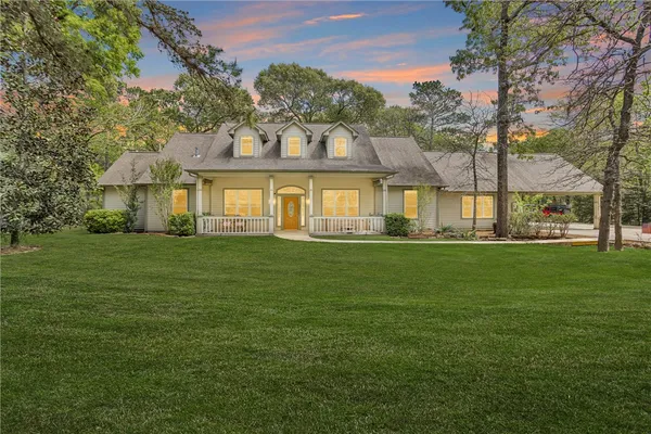 a front view of a house with a garden