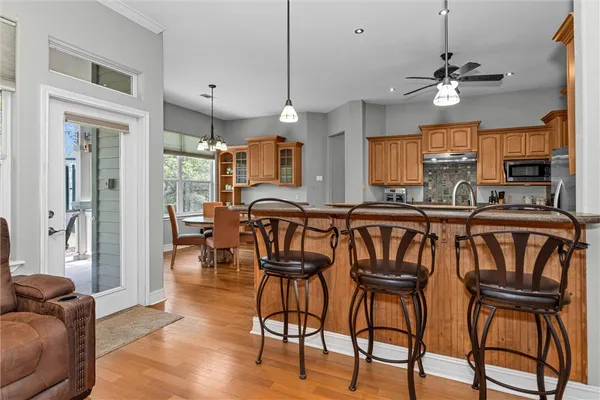 a dining room with furniture a chandelier and wooden floor