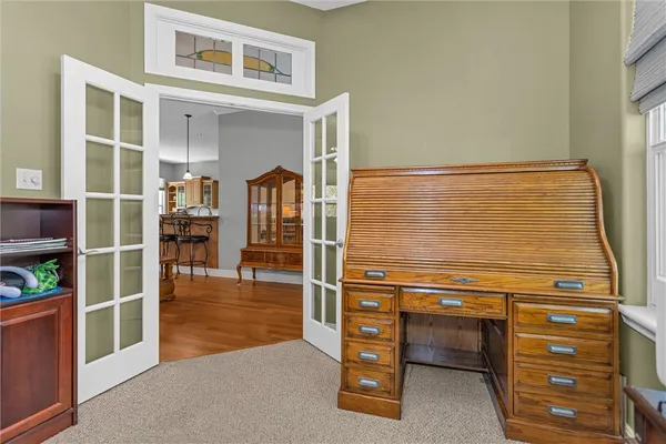 a dining room with wooden floor a chandelier a glass table and chairs