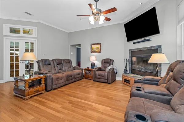 a kitchen with stainless steel appliances granite countertop a stove a sink dishwasher and cabinets with wooden floor