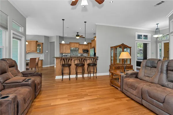 a kitchen with stainless steel appliances granite countertop a sink a stove and a refrigerator