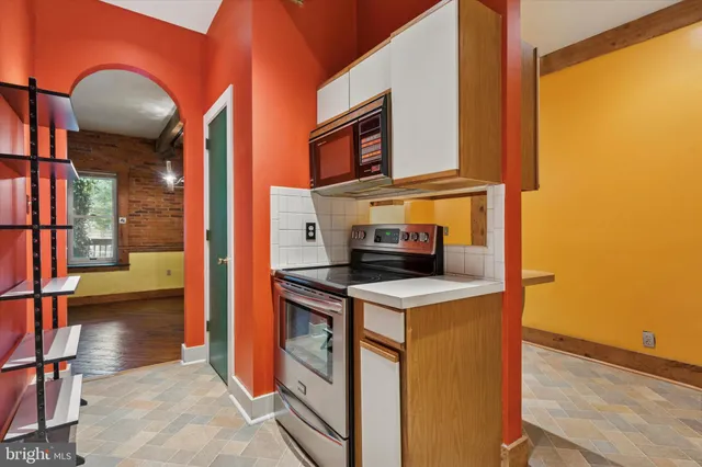 a kitchen that has a microwave and a stove