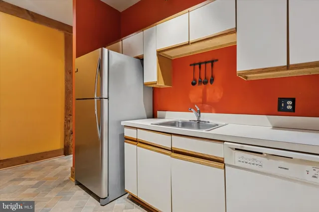 a kitchen with stainless steel appliances a refrigerator and a sink