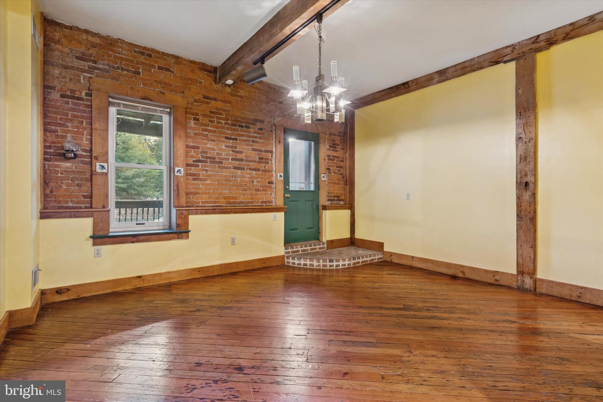 409 Lancaster Avenue Lancaster, PA 17603 - Photo 19 of 52 a view of an empty room with glass door and wooden floor