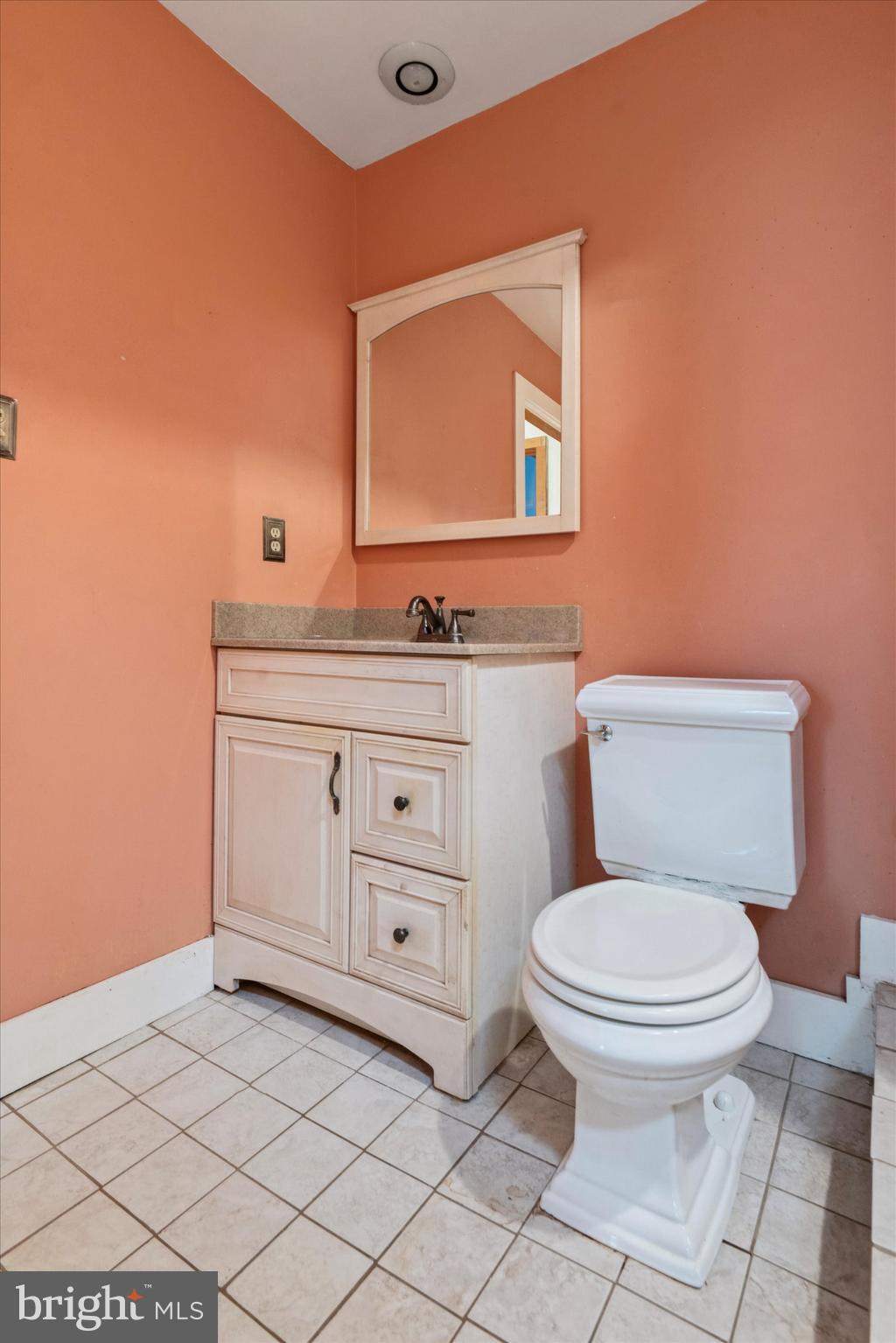 409 Lancaster Avenue Lancaster, PA 17603 - Photo 34 of 52 a bathroom with a toilet a sink a vanity and mirror