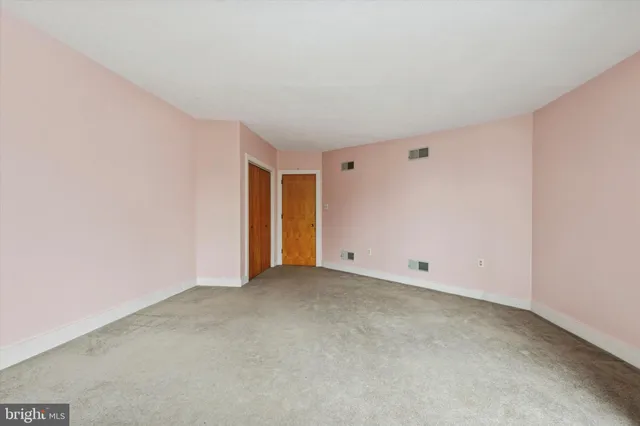 a bathroom with a toilet a window and tub