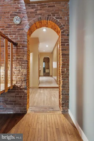 a view of a hallway with wooden floor and a fireplace