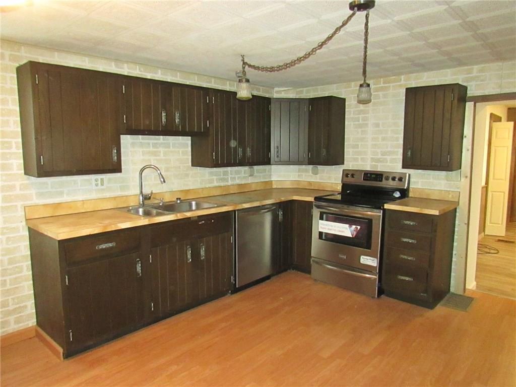 368 Kate Houk Road Wampum, PA 16157 - Photo 2 of 22 Eat in kitchen with new stainless steel appliances. Refrigerator and pantry on the other wall.
