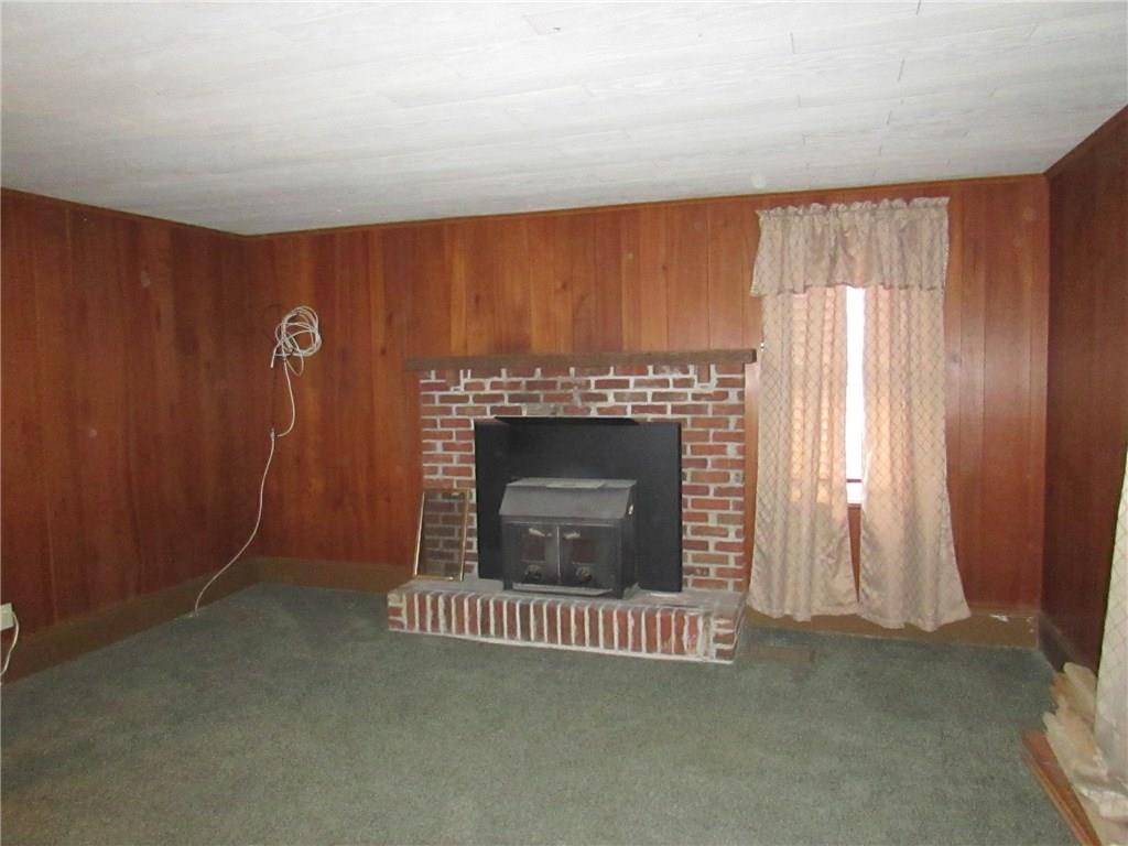 368 Kate Houk Road Wampum, PA 16157 - Photo 4 of 22 Living room with a wood burning insert in the fireplace.