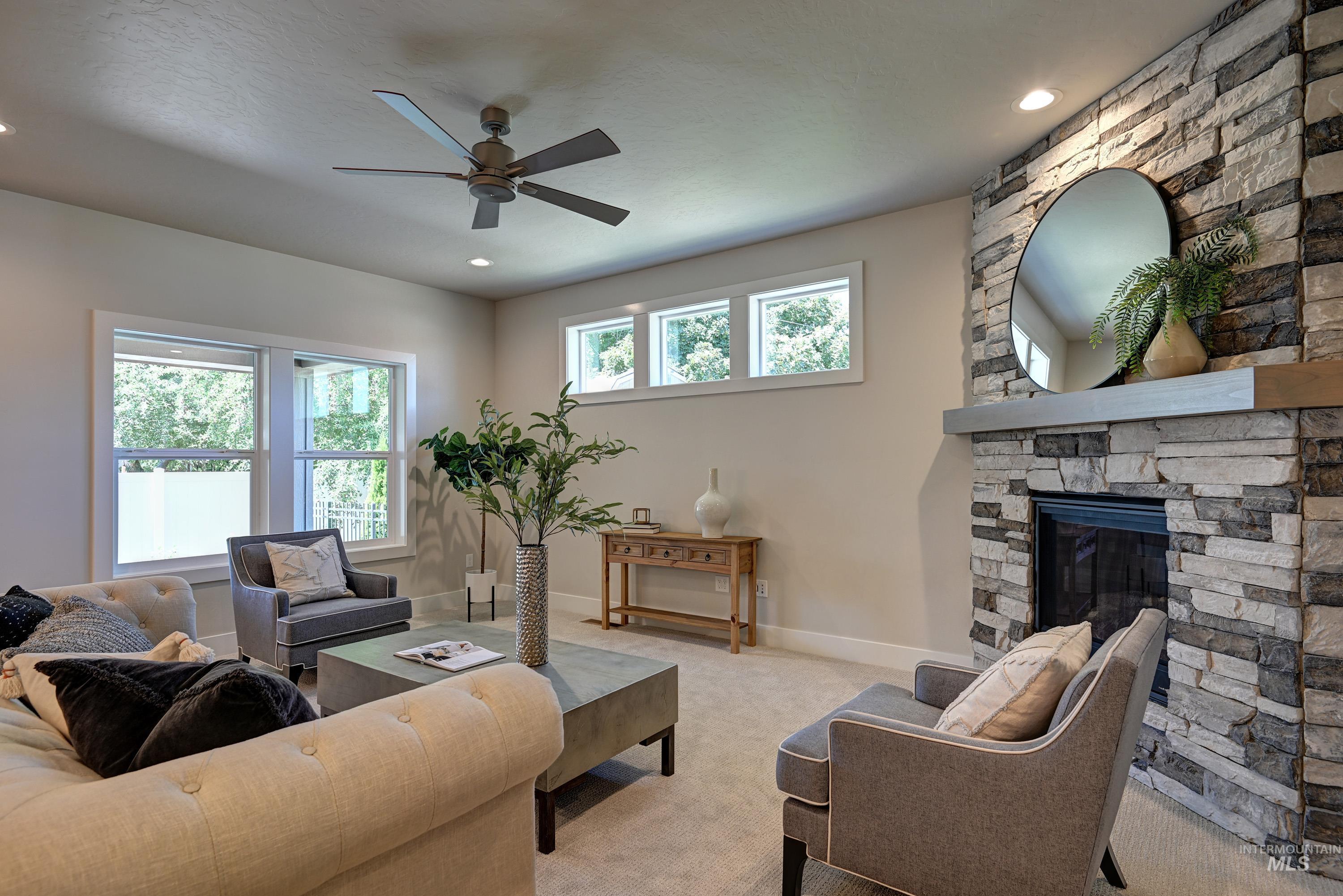 1469 North Parkshire Way Meridian, ID 83642 - Photo 11 of 43 Living area with a ceiling fan, light carpet, a fireplace, and recessed lighting