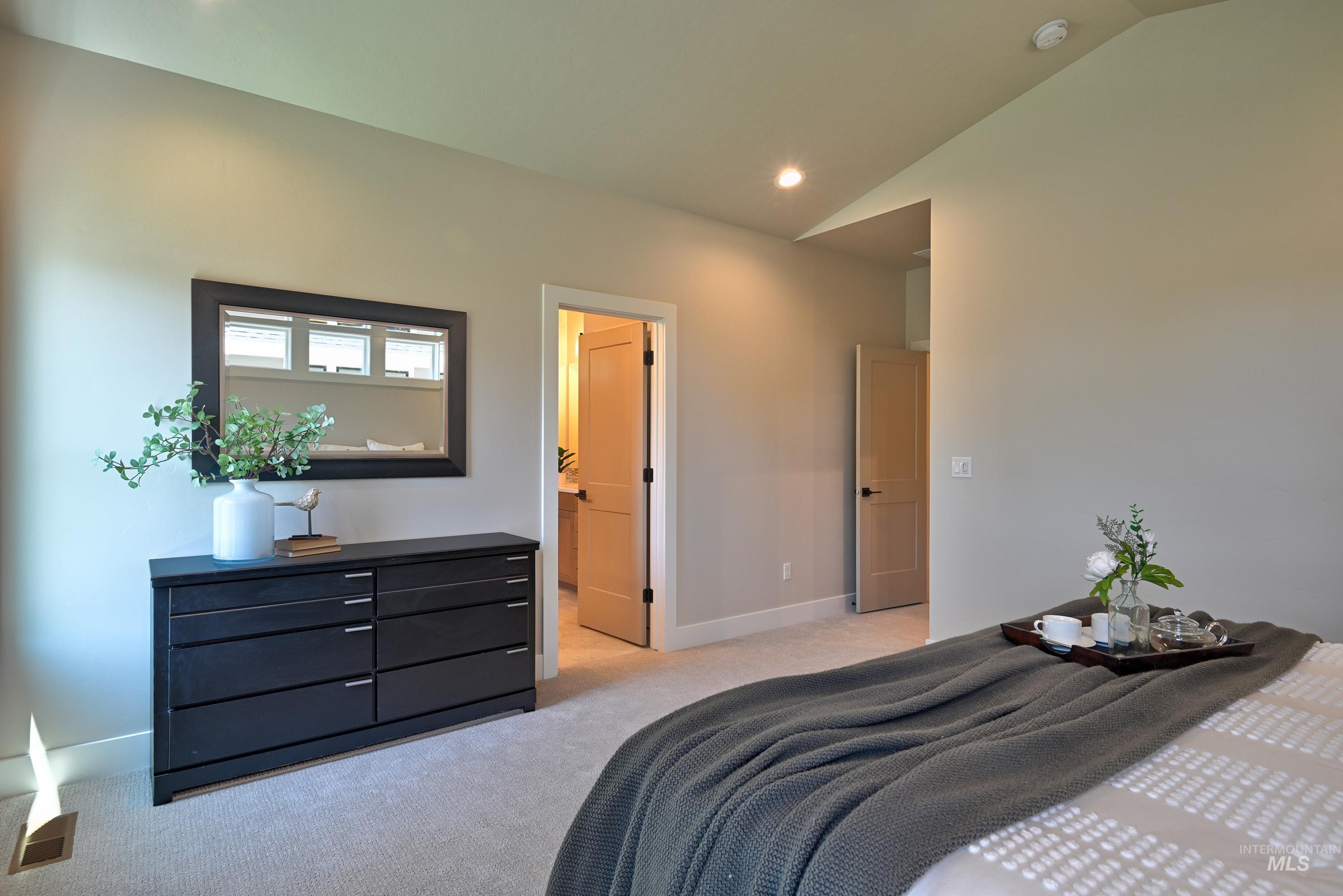 1469 North Parkshire Way Meridian, ID 83642 - Photo 23 of 43 Bedroom with light carpet, vaulted ceiling, and recessed lighting