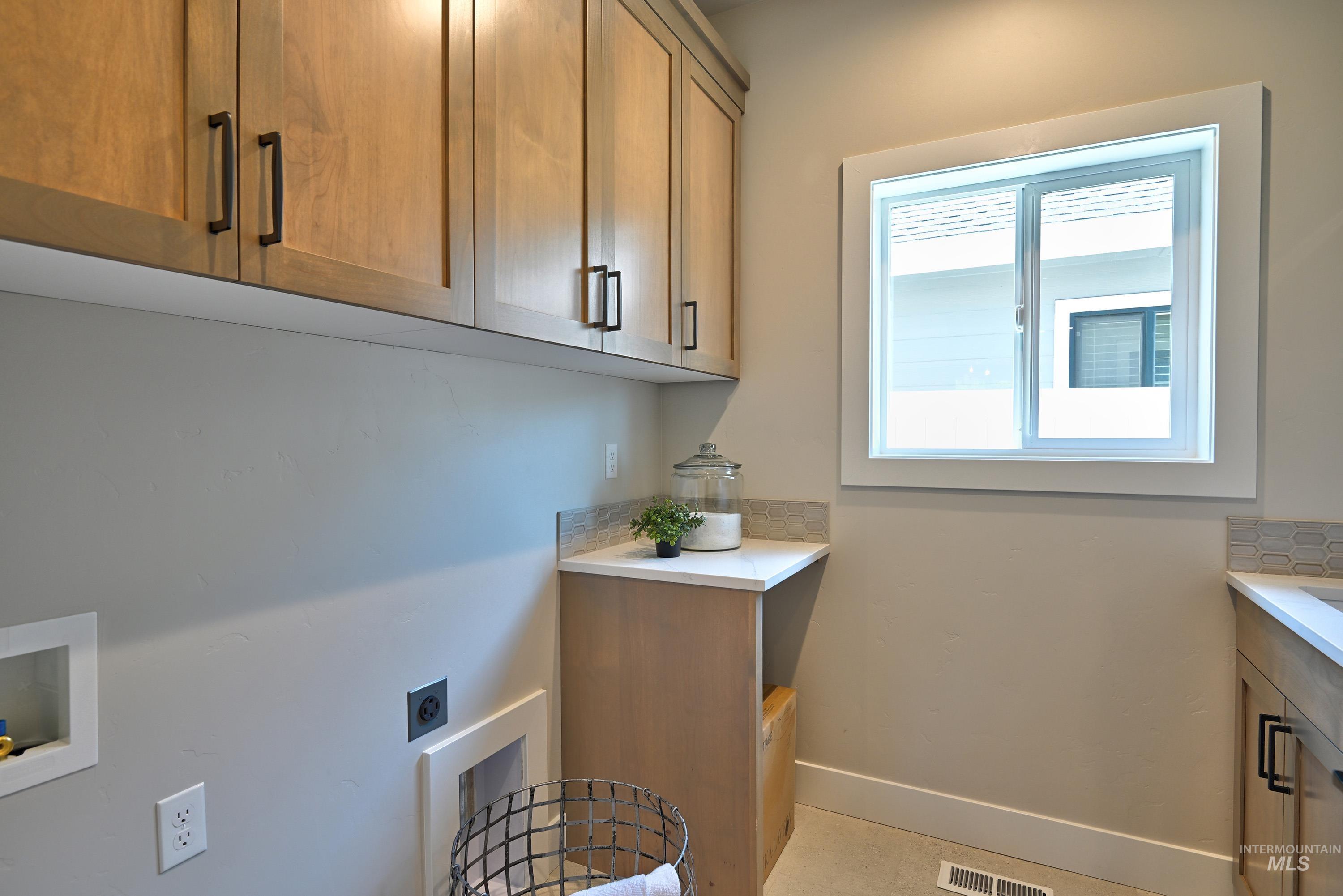 1469 North Parkshire Way Meridian, ID 83642 - Photo 30 of 43 Laundry area featuring hookup for an electric dryer, cabinet space, and hookup for a washing machine