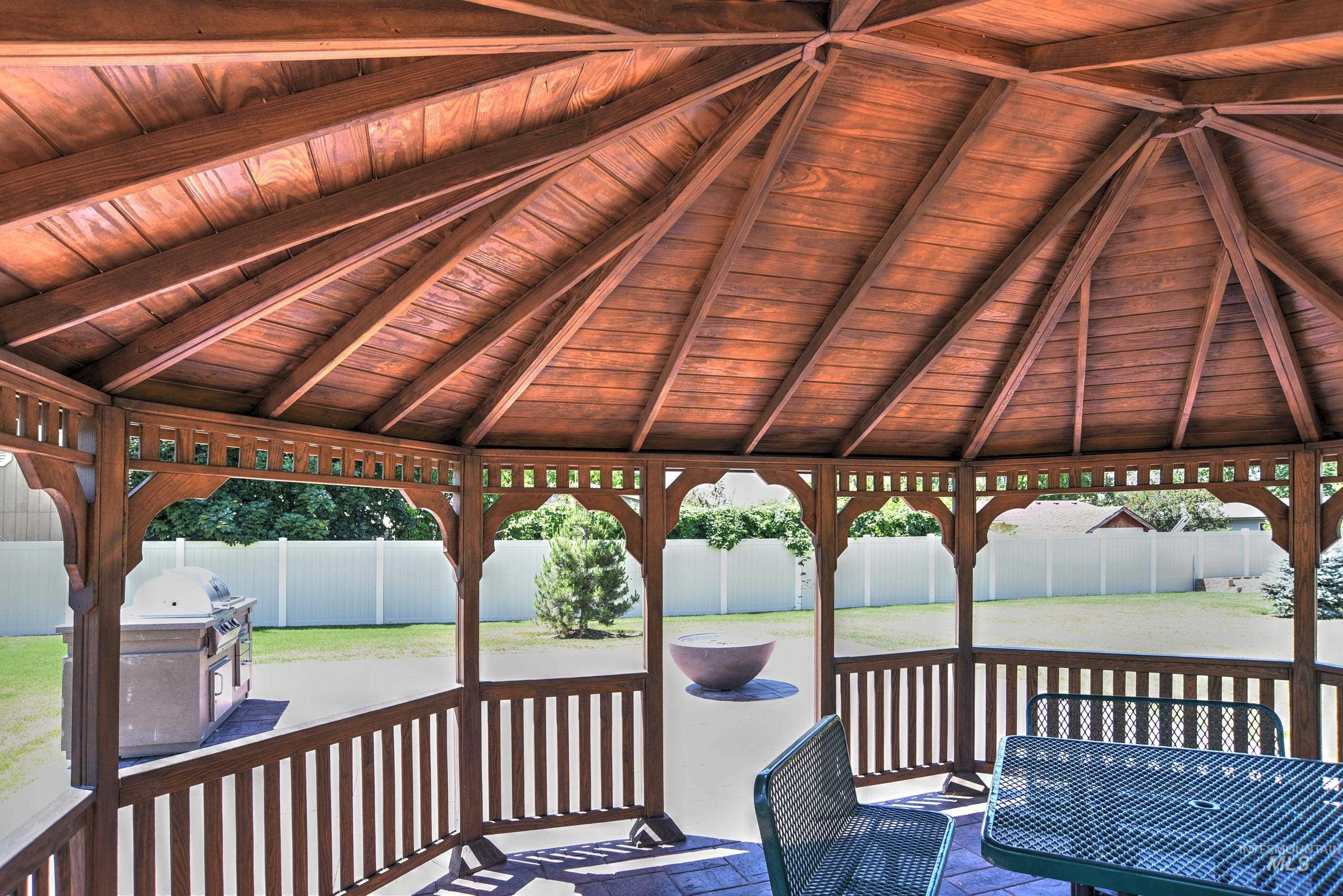 1469 North Parkshire Way Meridian, ID 83642 - Photo 36 of 43 Wooden deck with a gazebo, a fenced backyard, and a patio