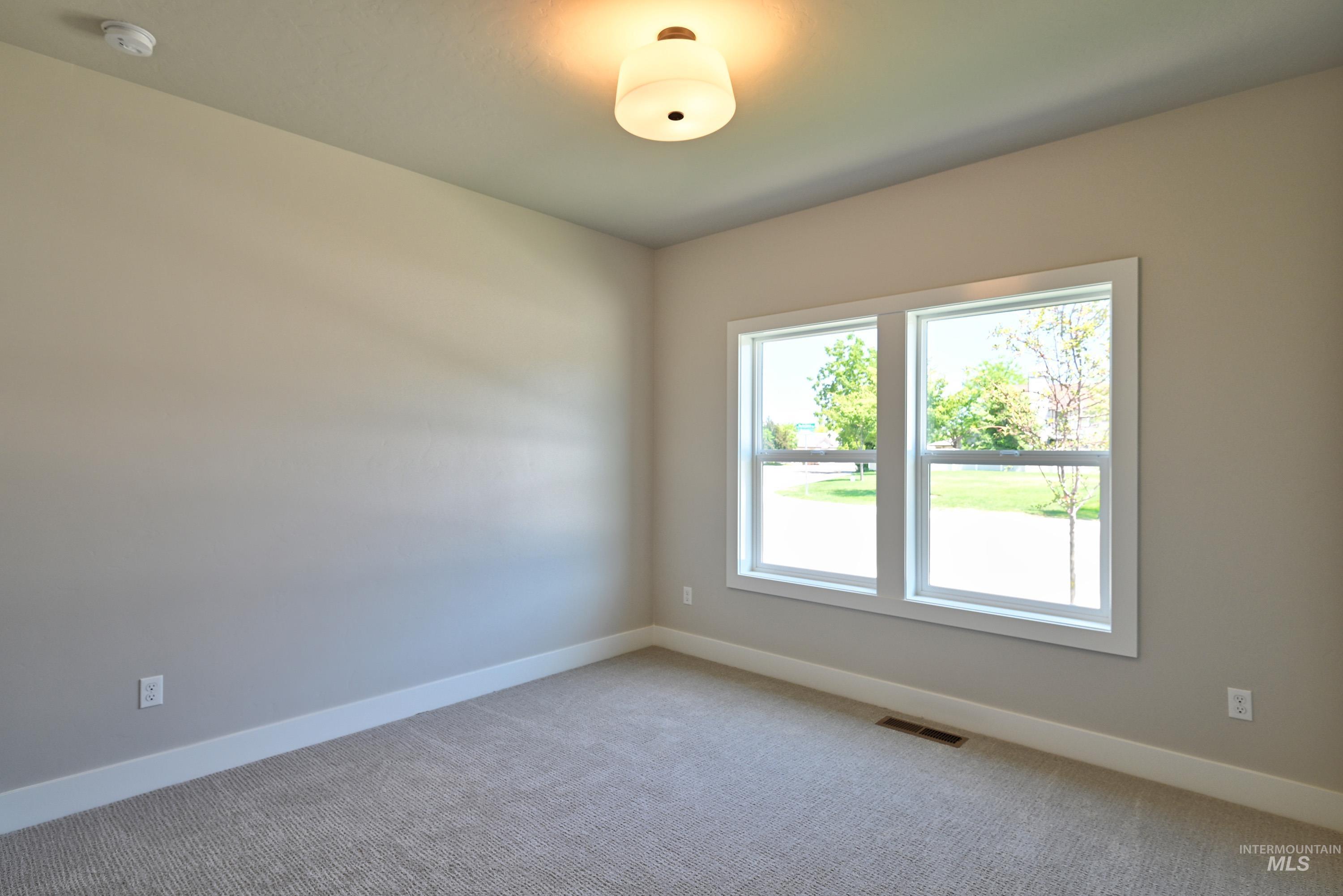 1469 North Parkshire Way Meridian, ID 83642 - Photo 6 of 43 Spare room featuring light carpet and a smoke detector