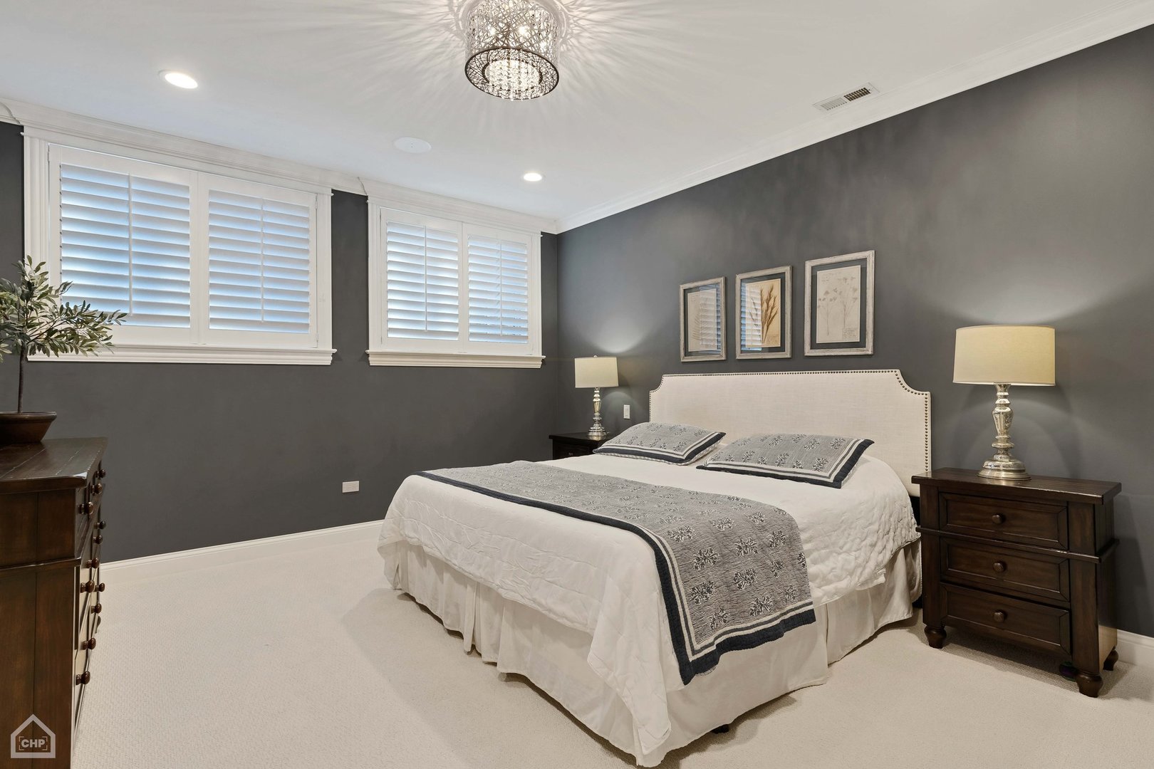 2242 North Seminary Avenue, Unit 1 Chicago, IL 60614 - Photo 15 of 37 a bedroom with a bed and a chandelier