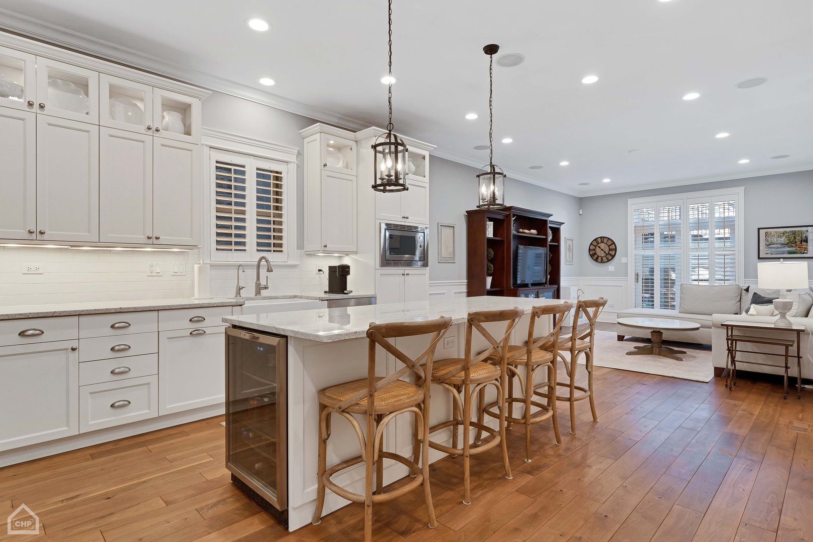 2242 North Seminary Avenue, Unit 1 Chicago, IL 60614 - Photo 7 of 37 a kitchen with stainless steel appliances kitchen island granite countertop a stove a sink a dining table and chairs with wooden floor