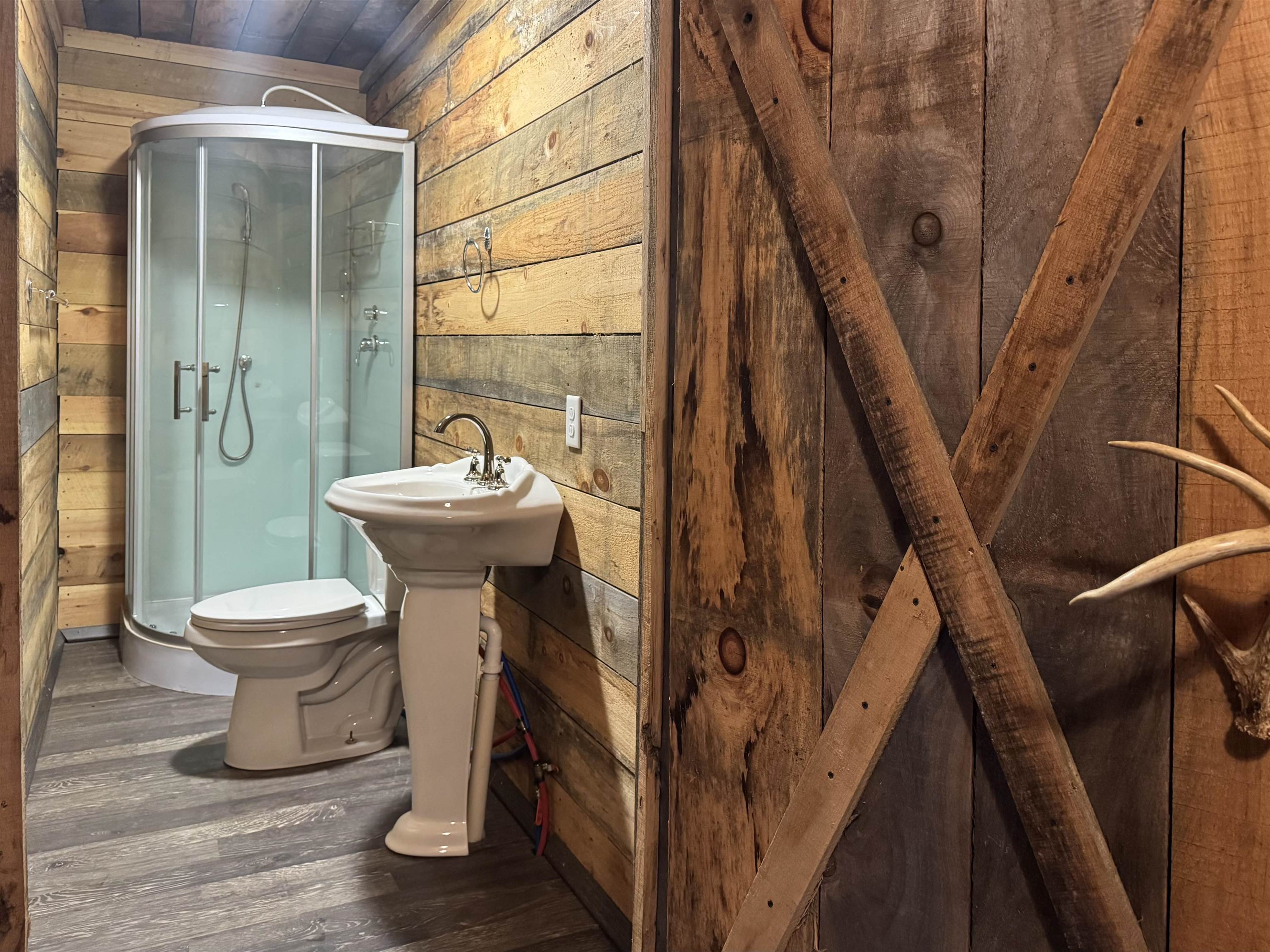 341 Buttercup Drive Mathias, WV 26812 - Photo 12 of 16 a bathroom with a sink mirror toilet and shower