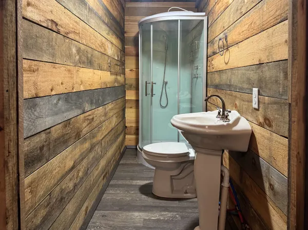 a view of an empty room with wooden floor