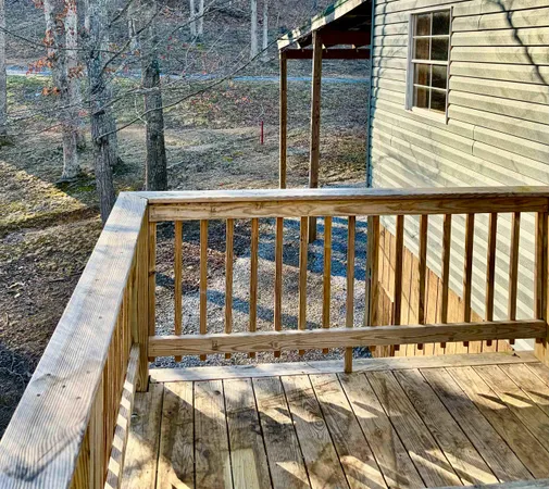 a living room with stainless steel appliances kitchen island granite countertop furniture and a flat screen tv