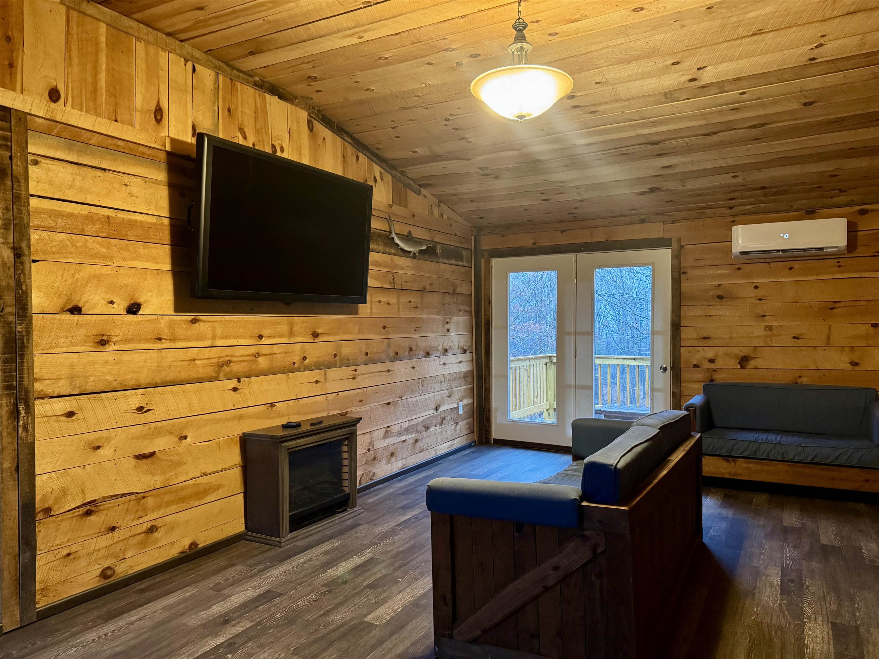 341 Buttercup Drive Mathias, WV 26812 - Photo 8 of 16 a living room with stainless steel appliances kitchen island granite countertop furniture and a flat screen tv