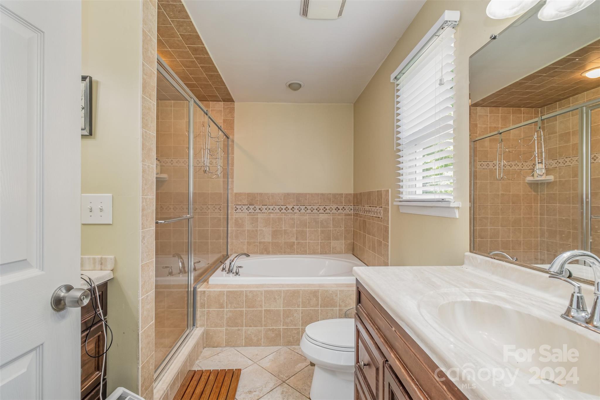 6200 Old Providence Road Charlotte, NC 28226 - Photo 13 of 24 a bathroom with a granite countertop bathtub sink vanity mirror and toilet