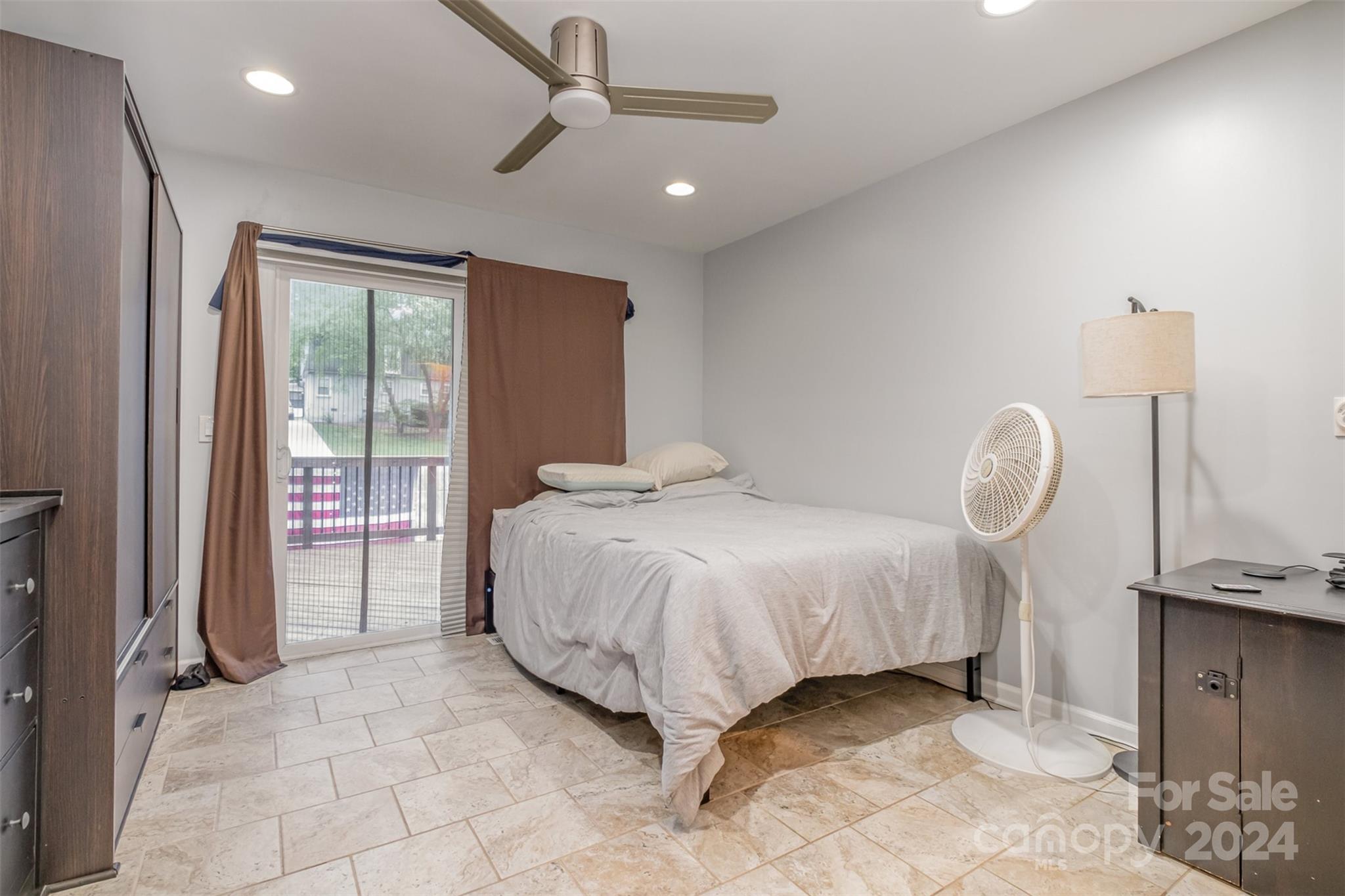 6200 Old Providence Road Charlotte, NC 28226 - Photo 21 of 24 a spacious bedroom with a bed a chandelier and a window