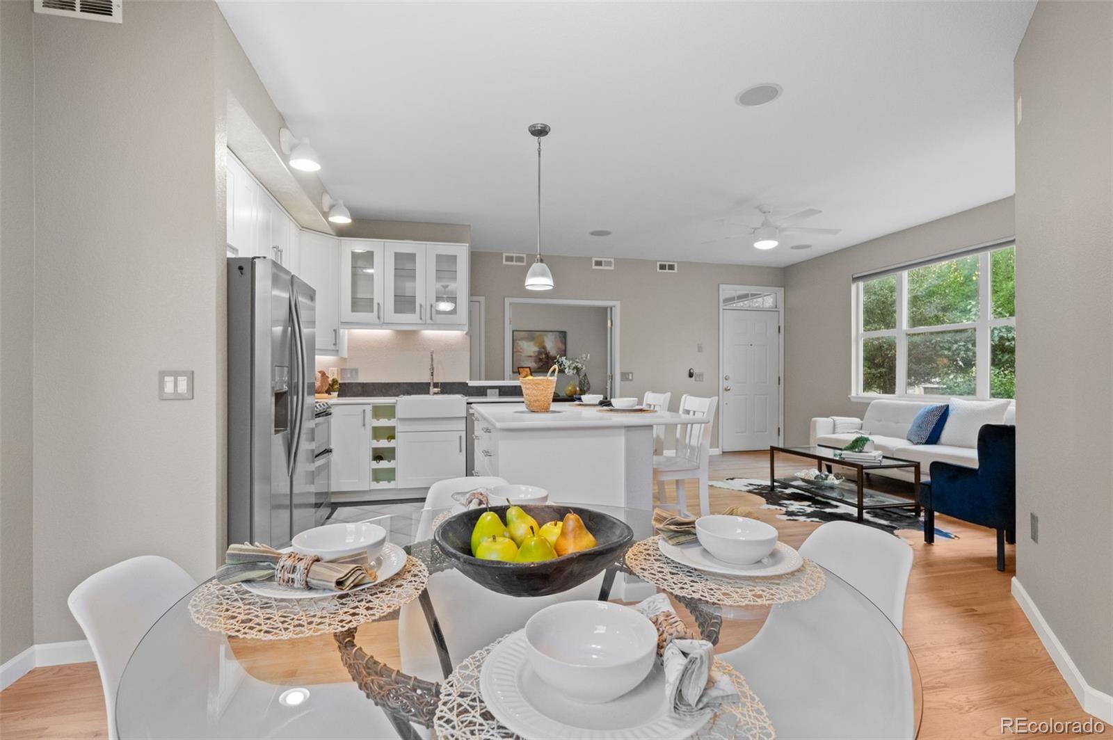 a living room with furniture and a dining table