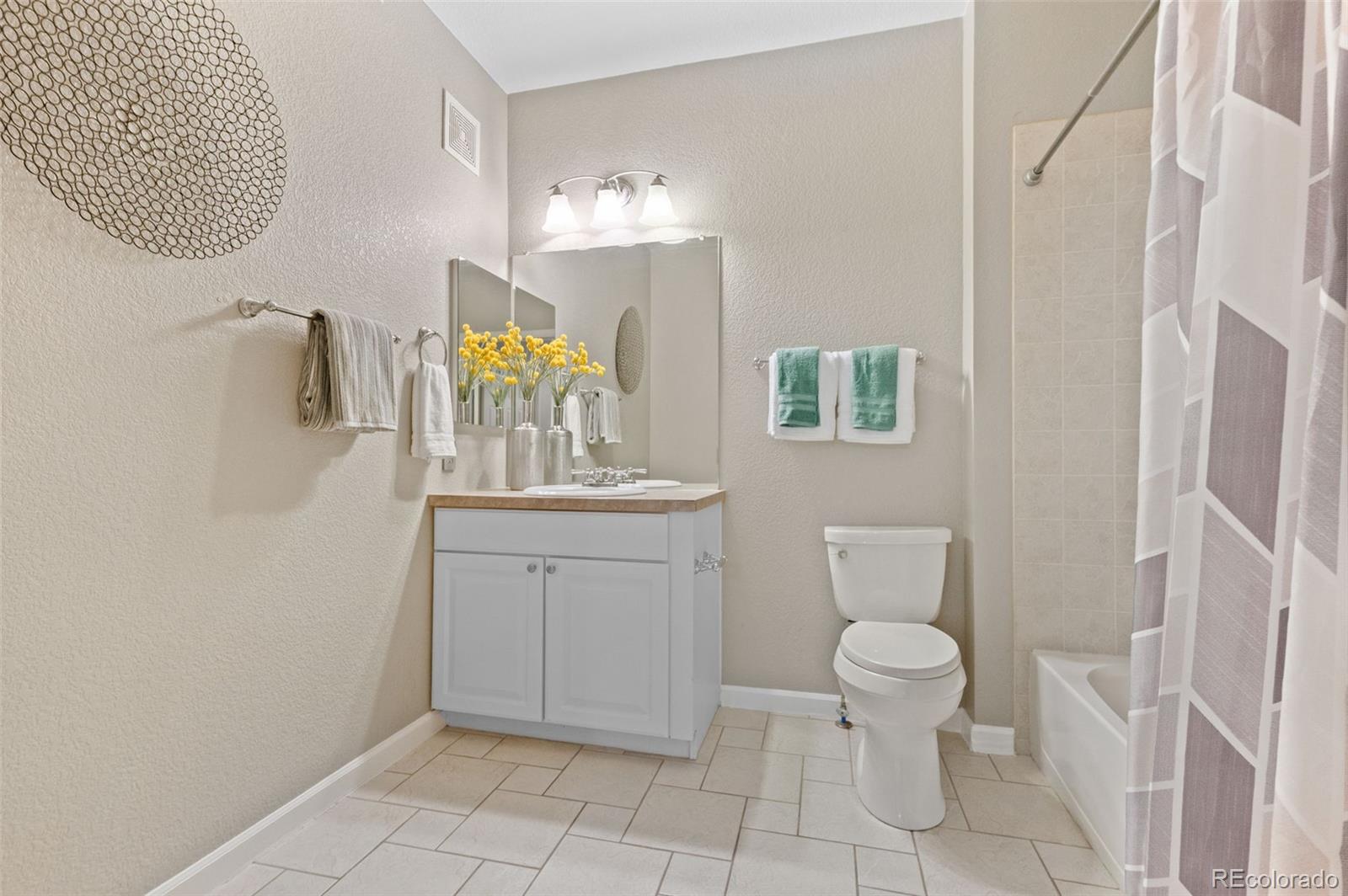 4501 Nelson Road, Unit 2104 Longmont, CO 80503 - Photo 11 of 29 a bathroom with a toilet sink and mirror