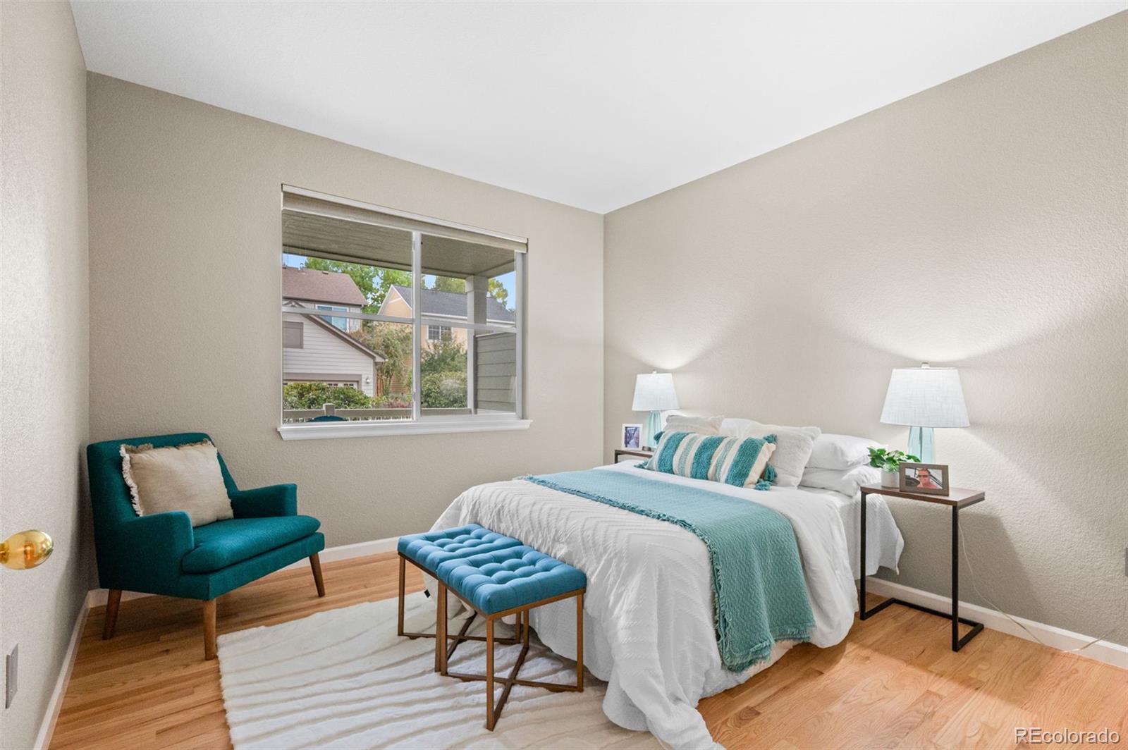 4501 Nelson Road, Unit 2104 Longmont, CO 80503 - Photo 12 of 29 a bedroom with a bed and wooden floor