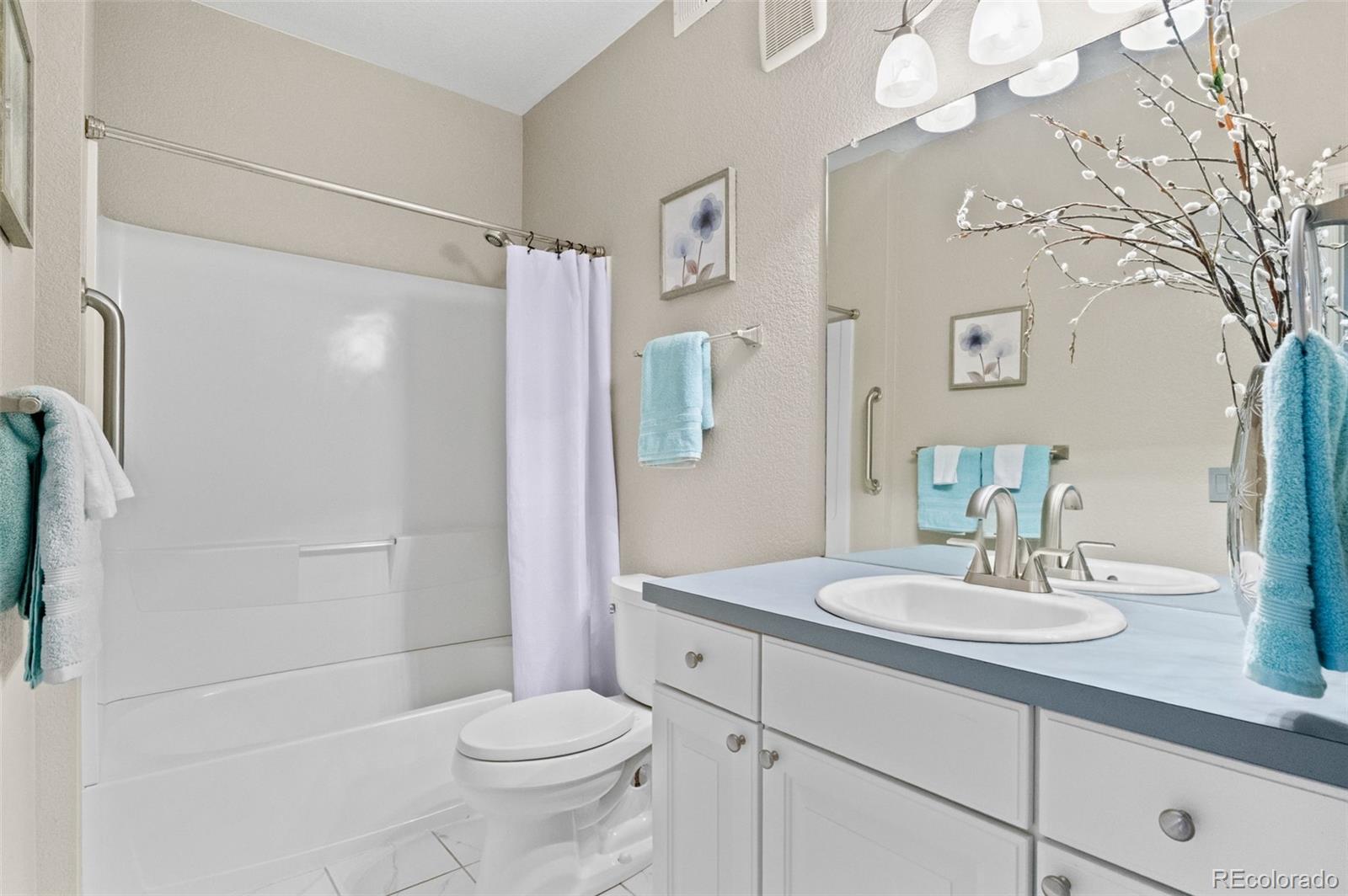 4501 Nelson Road, Unit 2104 Longmont, CO 80503 - Photo 15 of 29 a bathroom with a sink a toilet and shower