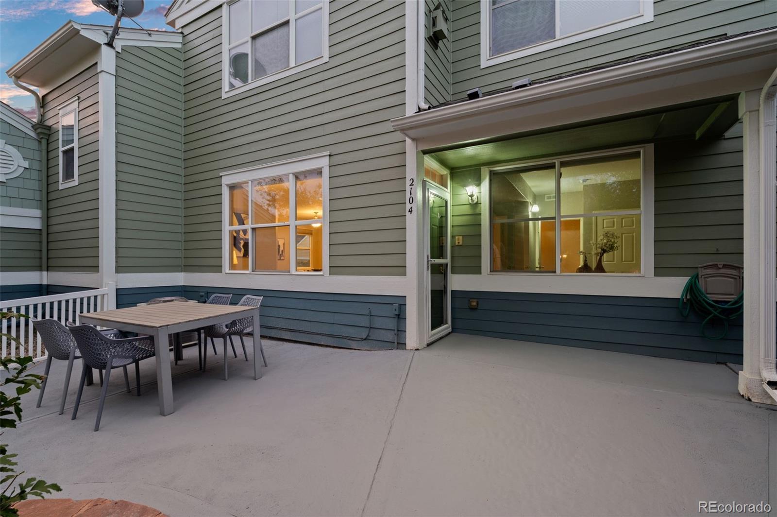 4501 Nelson Road, Unit 2104 Longmont, CO 80503 - Photo 19 of 29 a backyard of a house with barbeque oven table and chairs