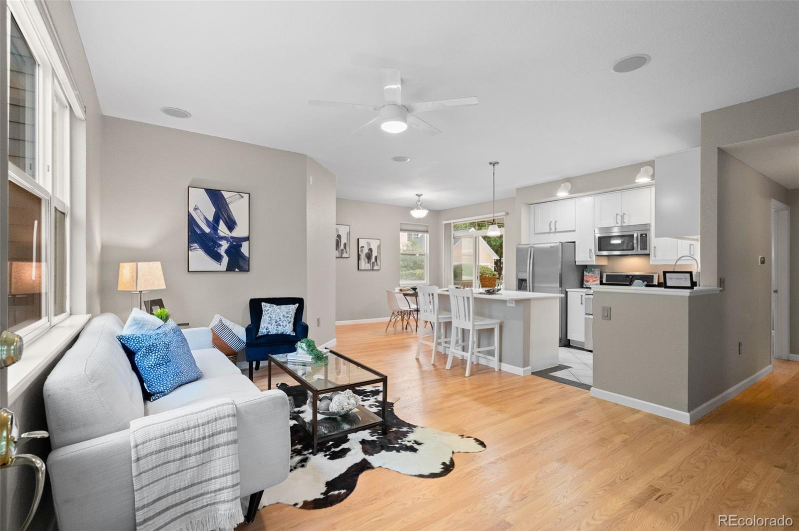 4501 Nelson Road, Unit 2104 Longmont, CO 80503 - Photo 2 of 29 a living room with furniture kitchen view and a wooden floor