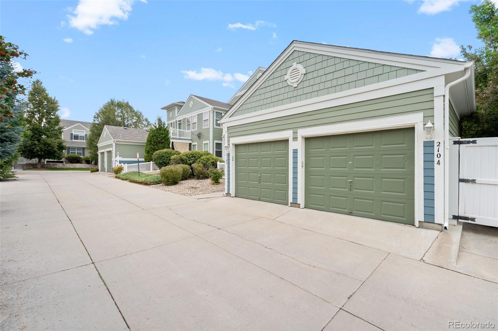 4501 Nelson Road, Unit 2104 Longmont, CO 80503 - Photo 23 of 29 a front view of a house with a yard and garage