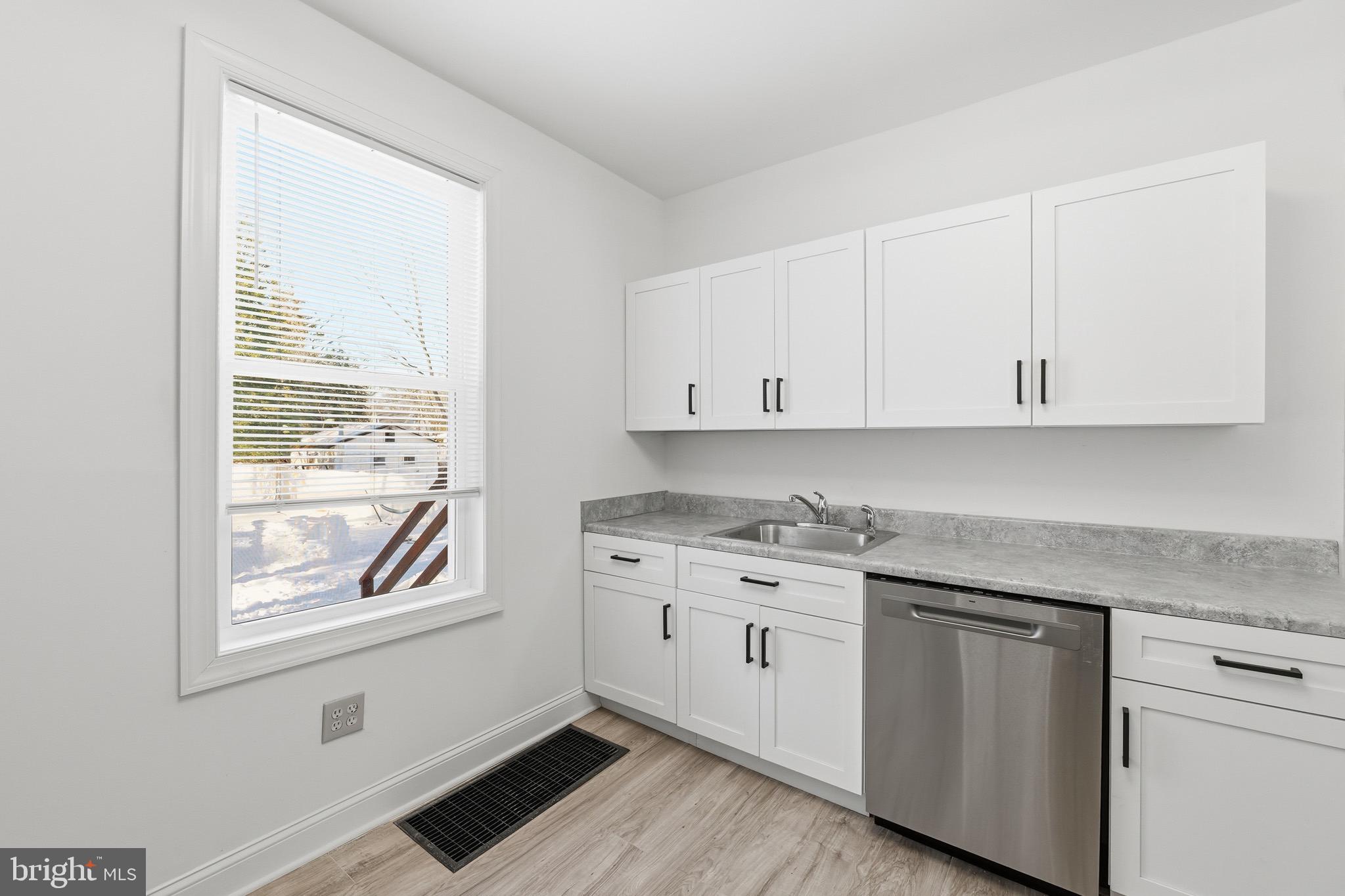357 West 2nd Street Moorestown, NJ 08057 - Photo 19 of 23 a kitchen with stainless steel appliances granite countertop white cabinets and window
