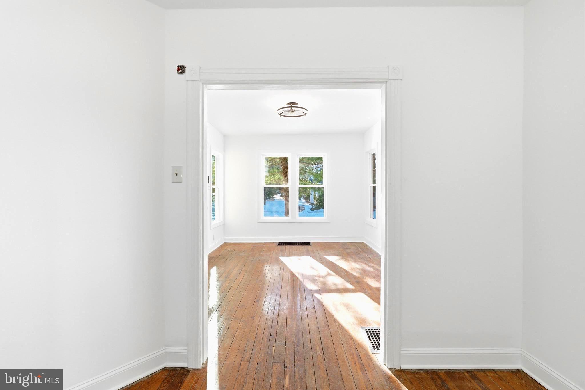 357 West 2nd Street Moorestown, NJ 08057 - Photo 6 of 23 a view of a hallway with wooden floor and a window